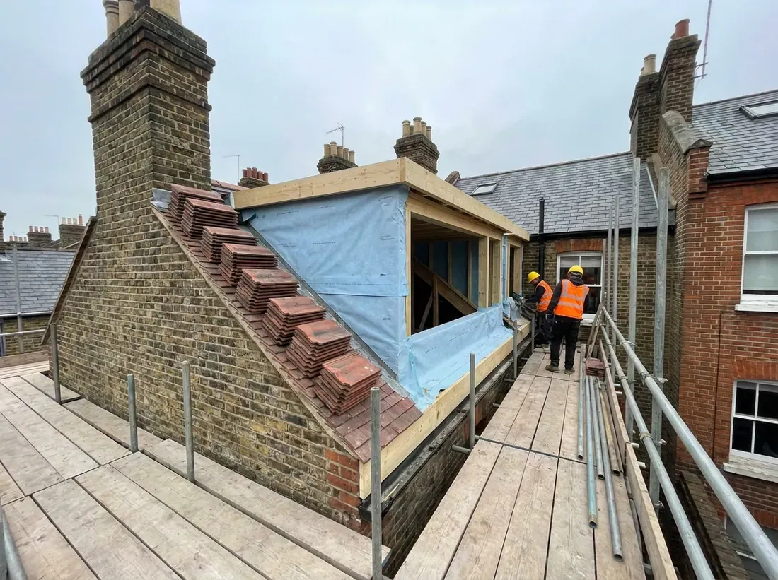 A new dormer frame built into a stripped rear roof slope