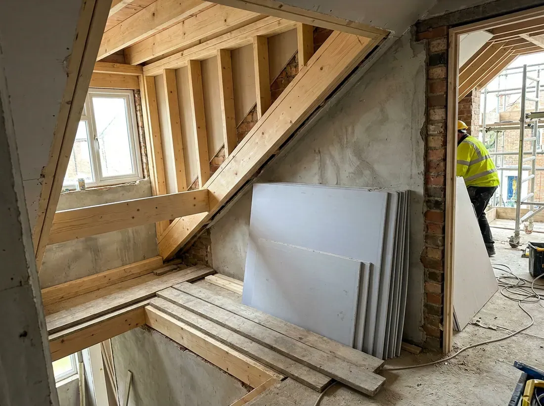 A new staircase opening framed through a landing ceiling into the loft