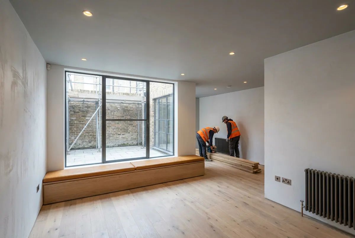 A finished basement room lit by a lightwell